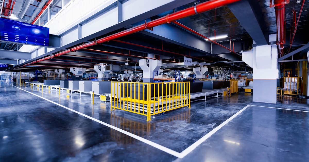 a large industrial building with a yellow gate