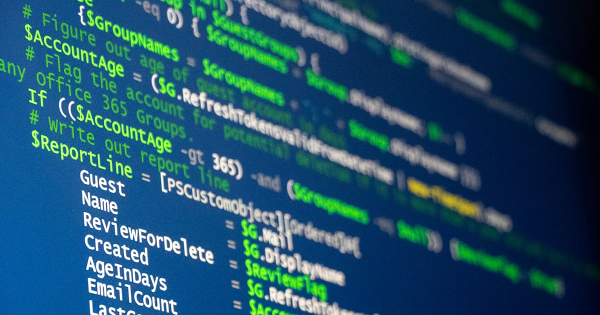 Computer code is displayed on a screen.