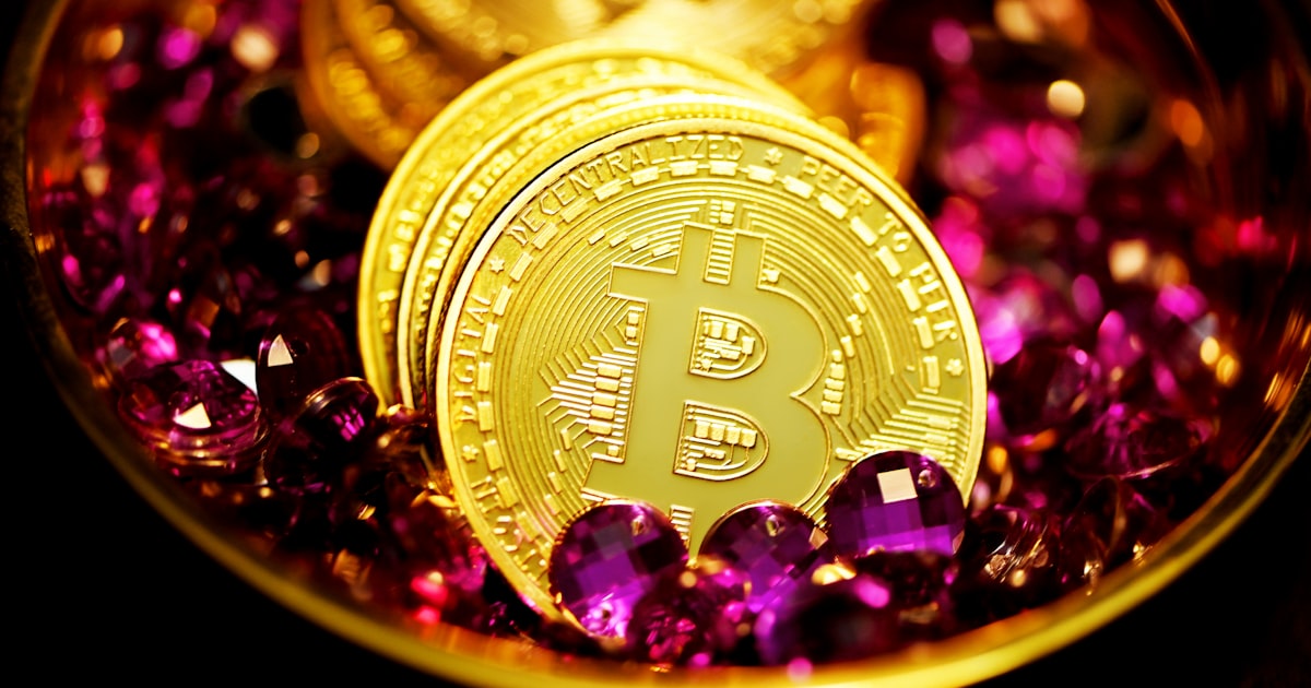 a close up of a bitcoin surrounded by purple crystals