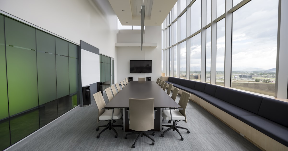 rectangular brown wooden table with chair lot inside building