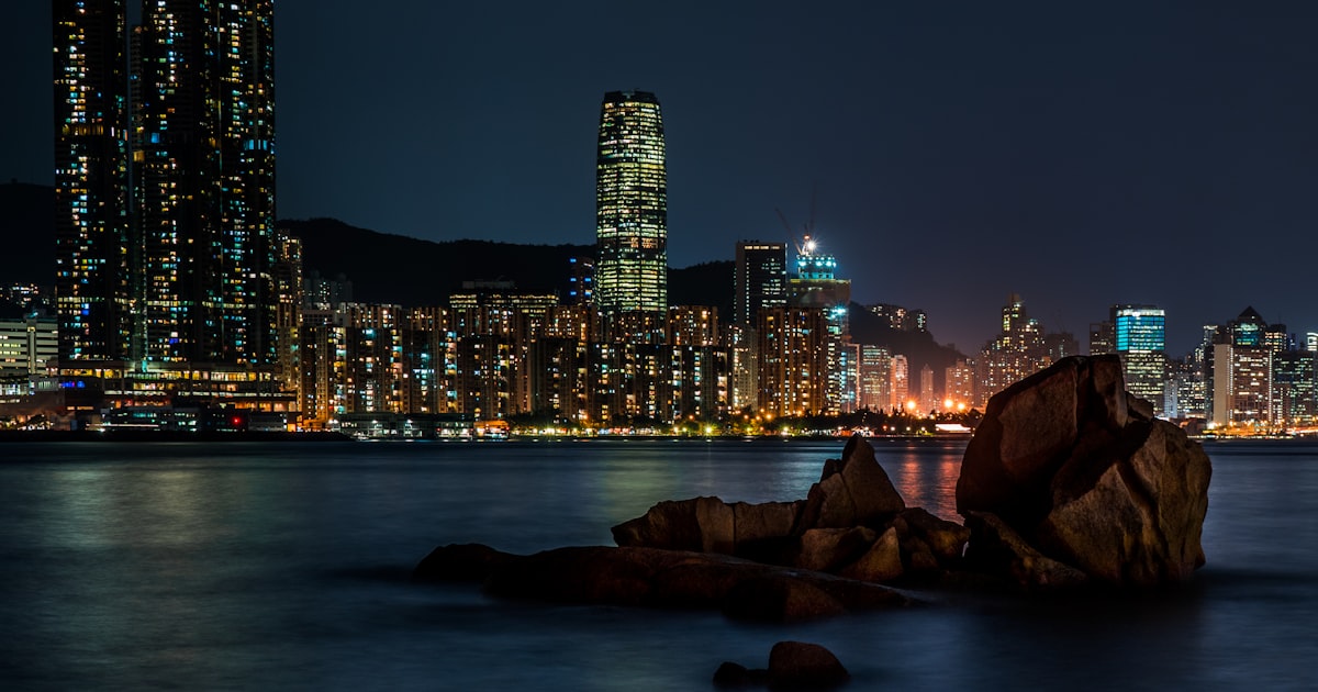 a large body of water with a city in the background