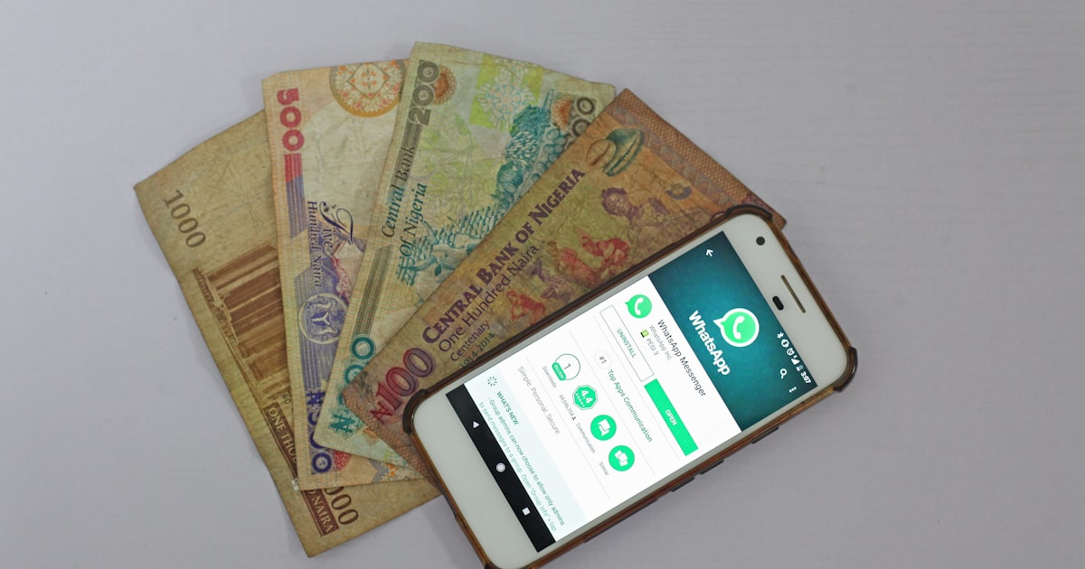 white Android smartphone beside banknotes