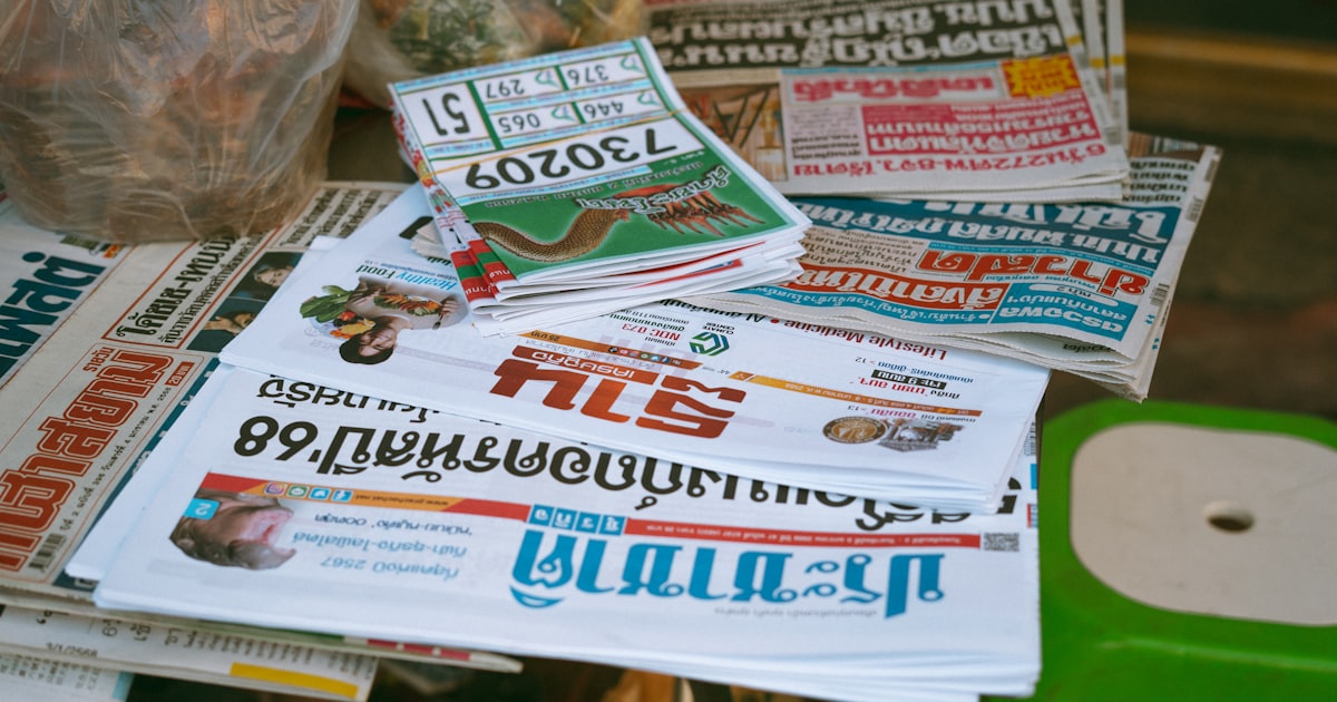 Newspapers and lottery tickets are displayed.