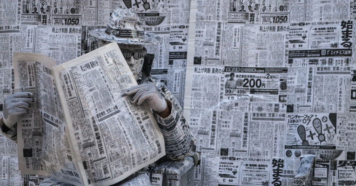 a newspaper with a person holding a newspaper