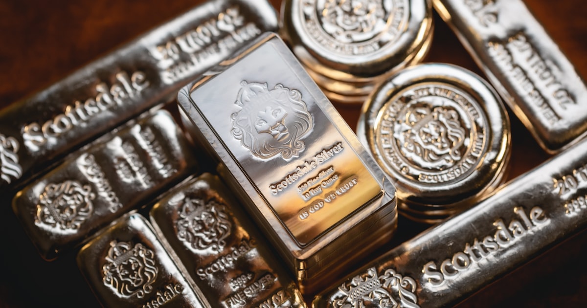 a bunch of silver bars sitting on top of each other