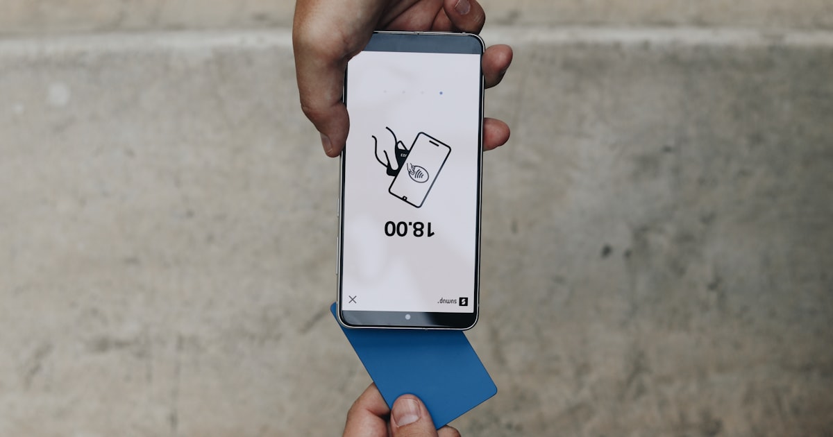 A person holding a box with a cat on it