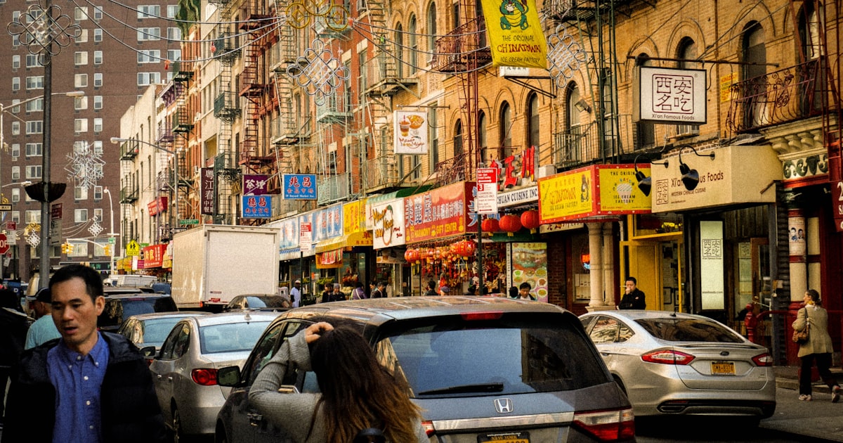people walking on street near vehicles