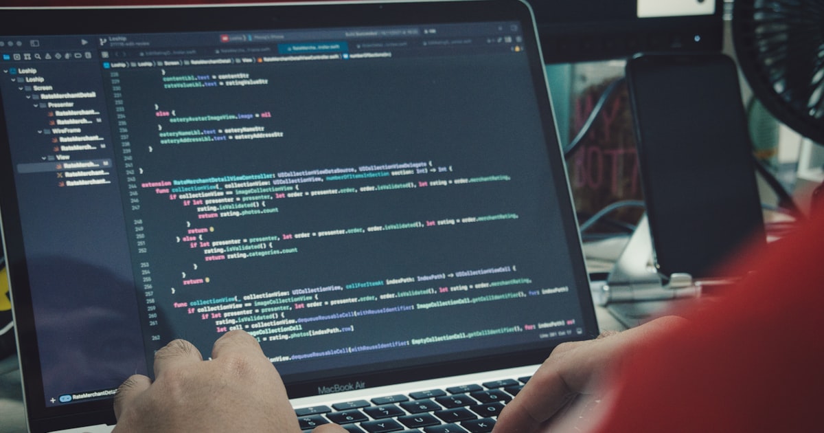a man sitting in front of a laptop computer