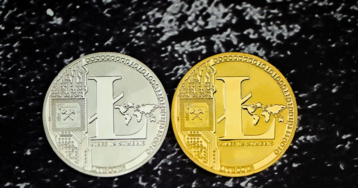 two gold and silver coins sitting side by side