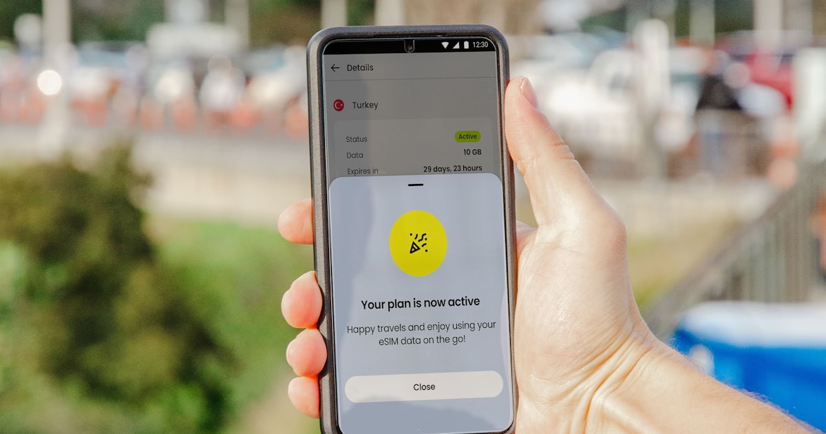 a person holding a cell phone in their hand