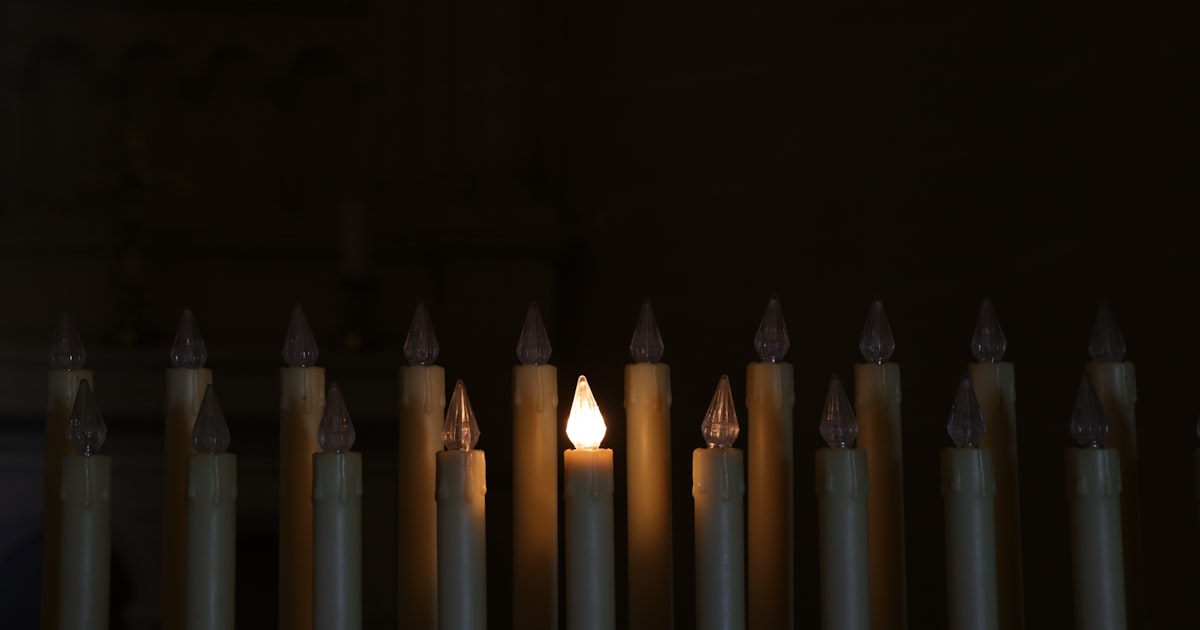 a group of lit candles sitting next to each other