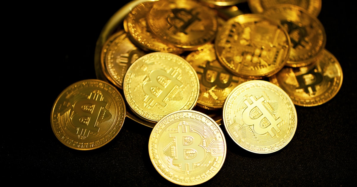 gold round coins on black surface