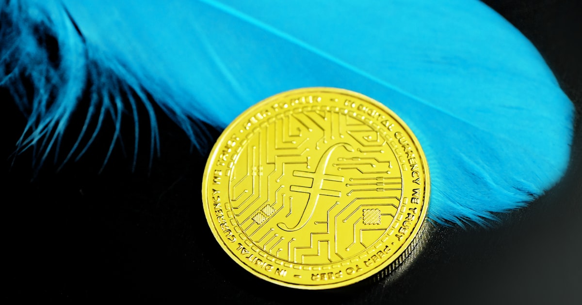 a bit coin sitting on top of a blue feather