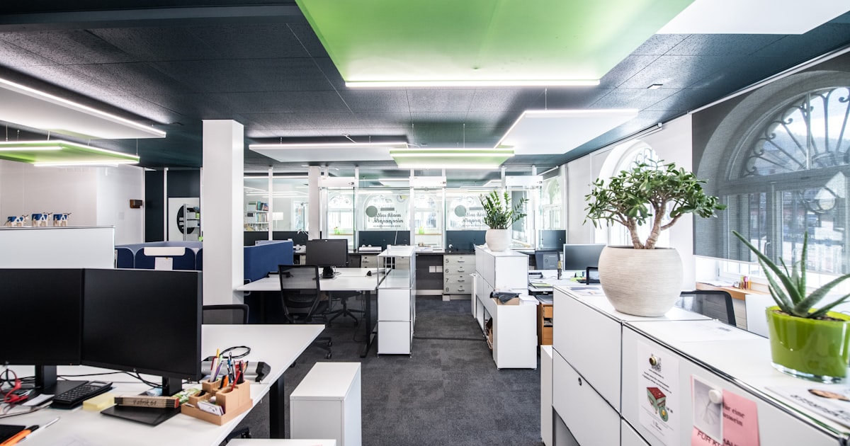 an office with white cabinets and desks
