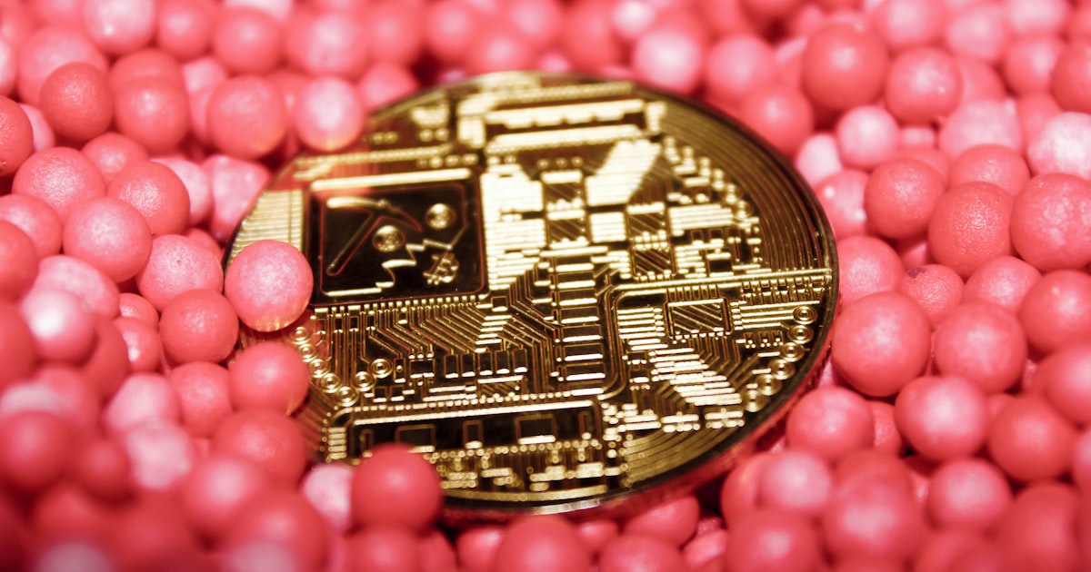 a close up of a coin surrounded by pink balls