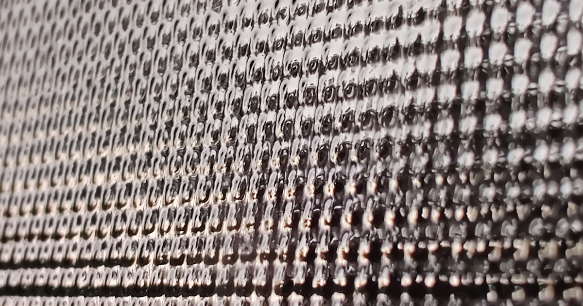 white and black textile with yellow and orange beads