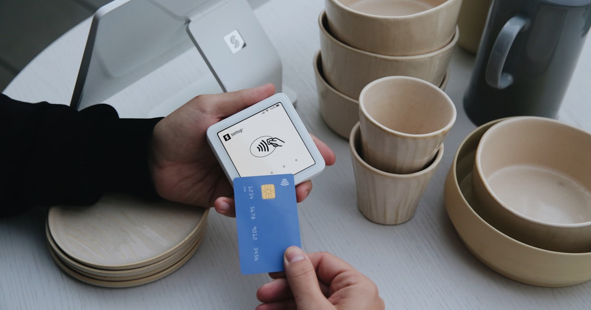 A person uses a credit card to pay.