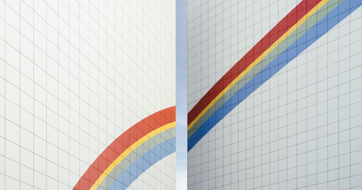 a couple of white walls with a rainbow painted on them