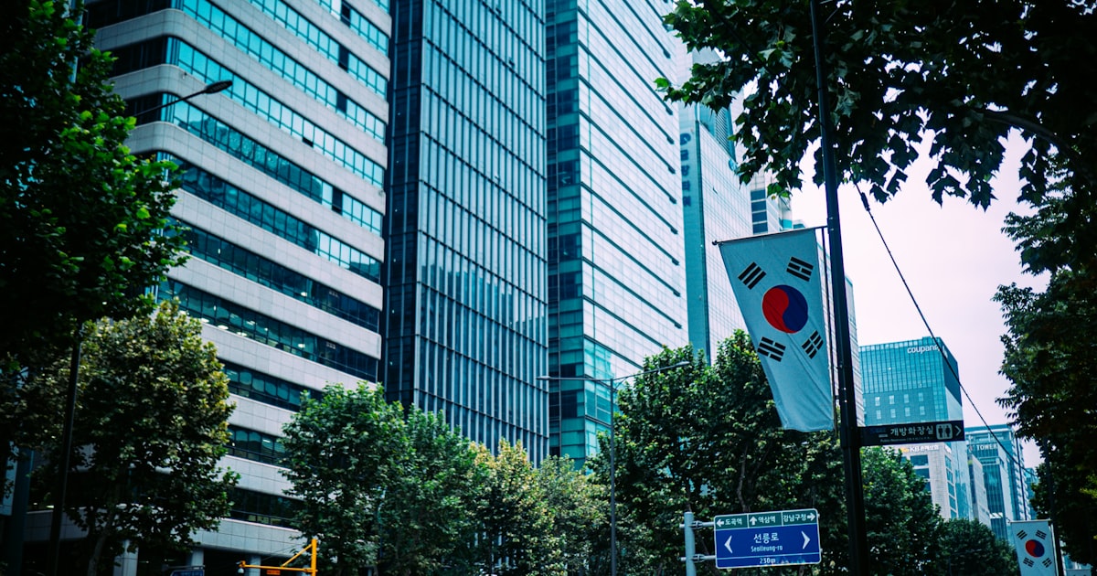 Modern skyscrapers with trees and korean flag