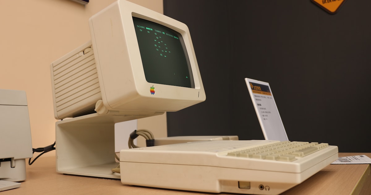 A computer sitting on top of a wooden desk