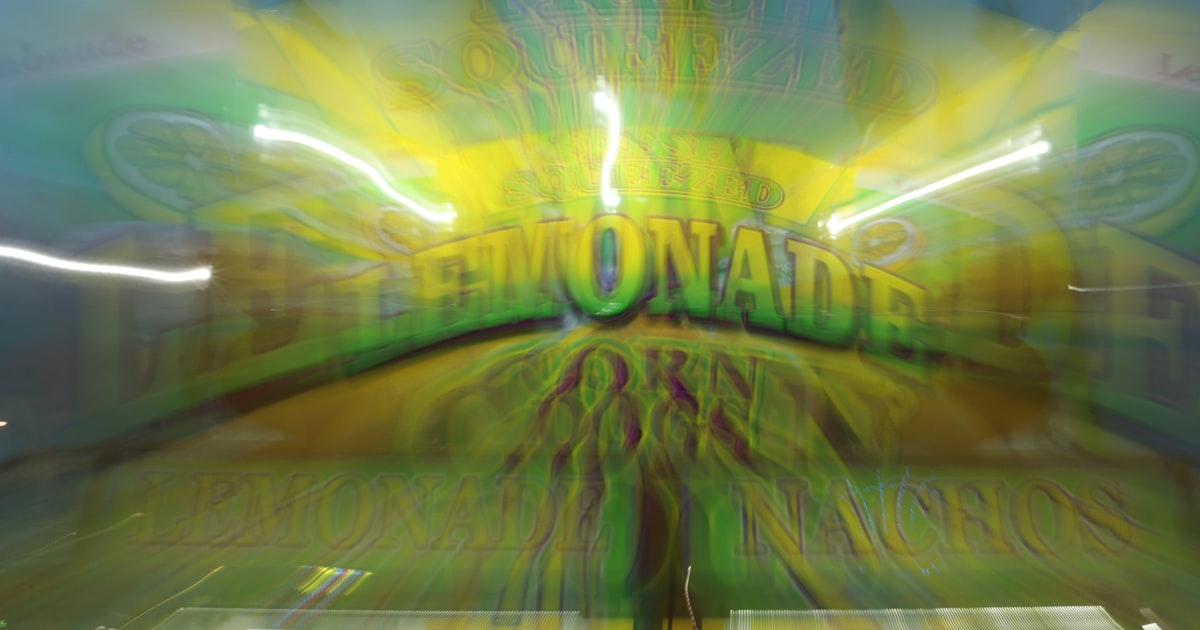 Blurry sign for lemonade with bright yellow and green colors.