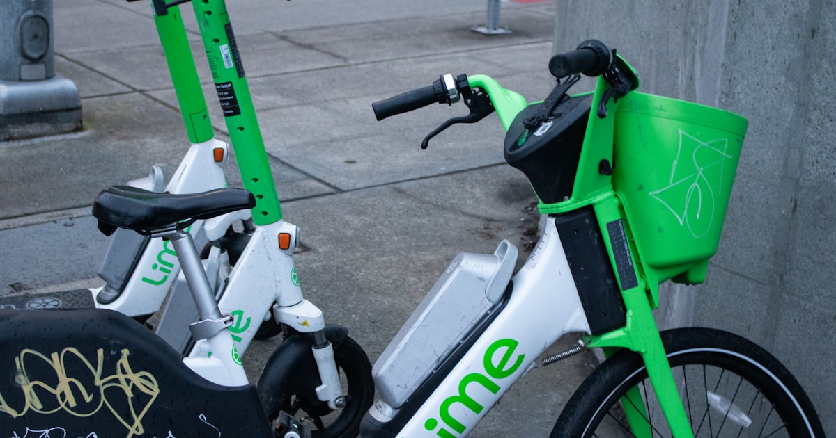 Lime scooters are parked on the sidewalk.