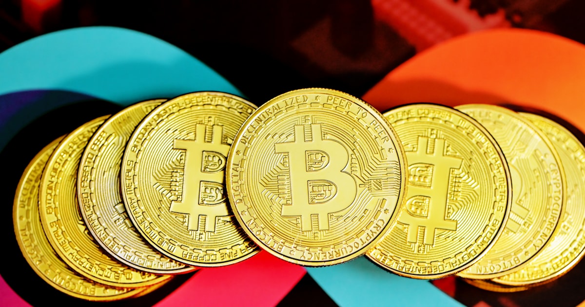 gold round coin on red textile