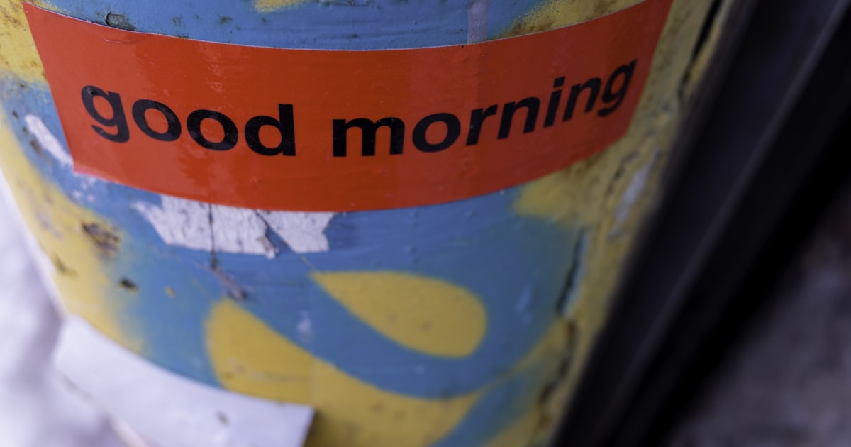 Red sticker with "good morning" text on yellow background.
