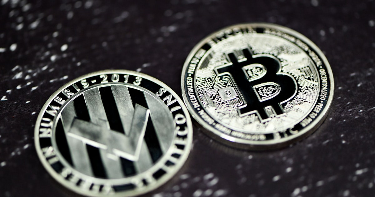 two bitcoins sitting side by side on a table