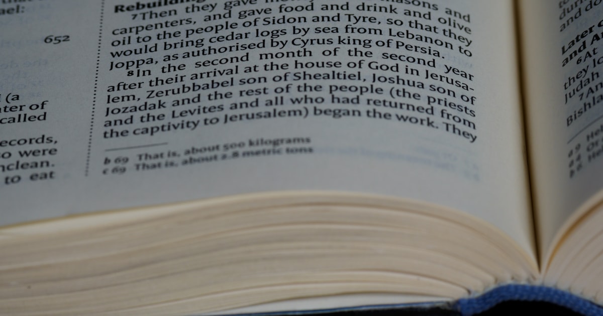 an open book sitting on top of a wooden table