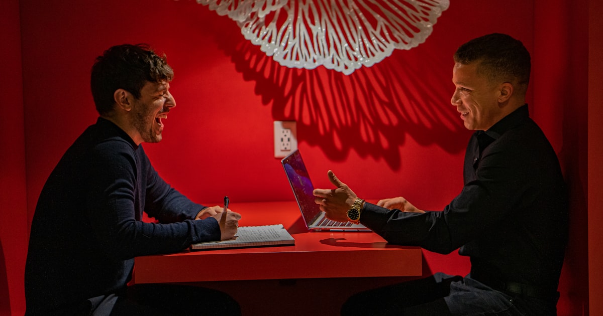 man in black long sleeve shirt sitting on chair