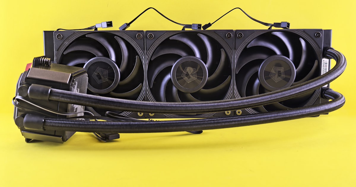 A computer liquid cooler on a yellow background.