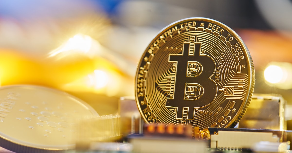 a bit coin sitting on top of a computer chip