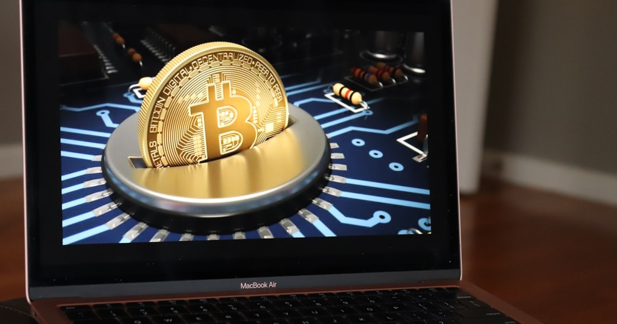 a laptop with a bitcoin on the screen
