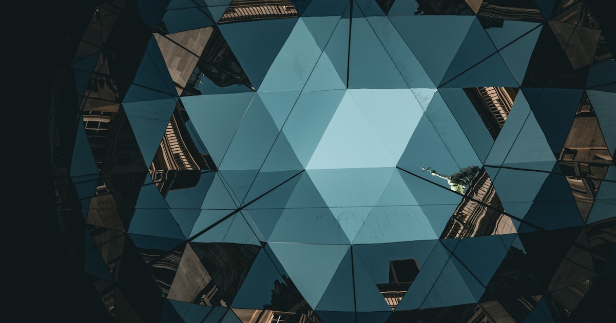 Abstract blue geometric pattern with building reflections.