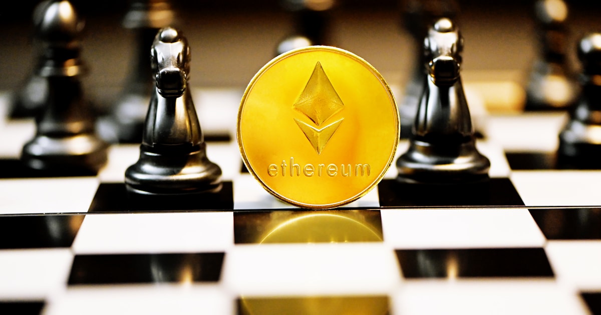 a gold ether coin sitting on top of a chess board
