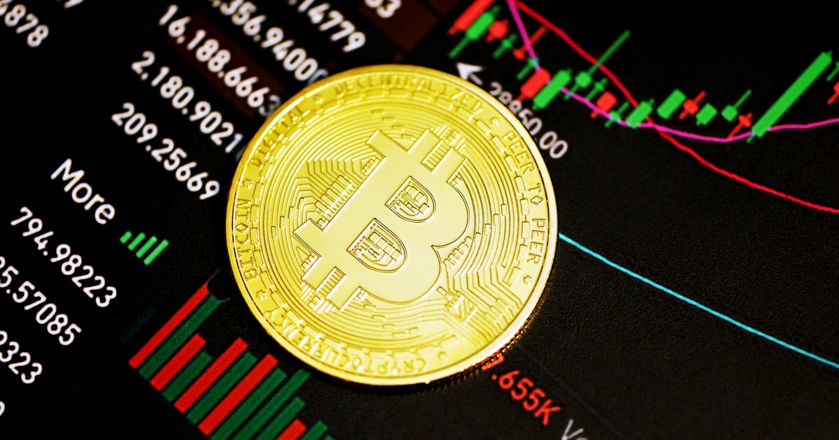 gold round coin on black surface