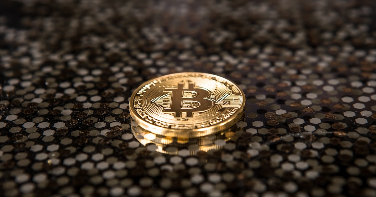 gold-colored Bitcoin coin on ground