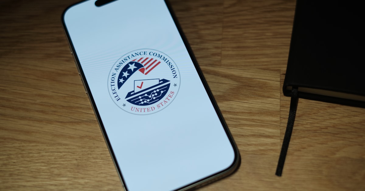 A cell phone sitting on top of a wooden table