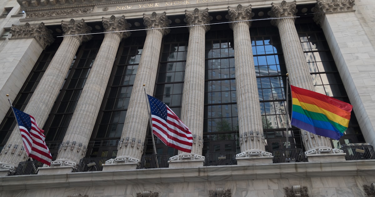 a group of flags flying in front of a building
