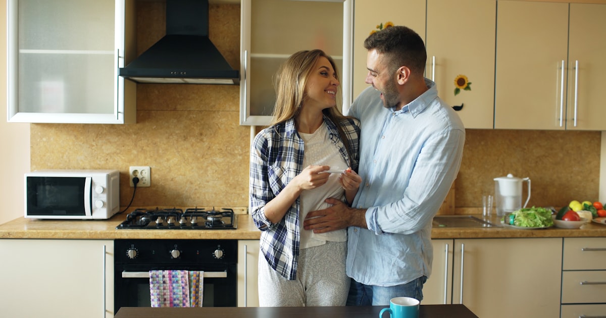 Couple embracing in a modern kitchen
