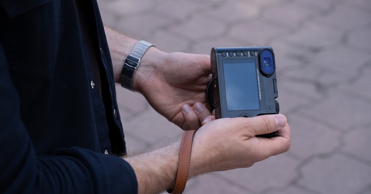 a man holding a cell phone in his hand