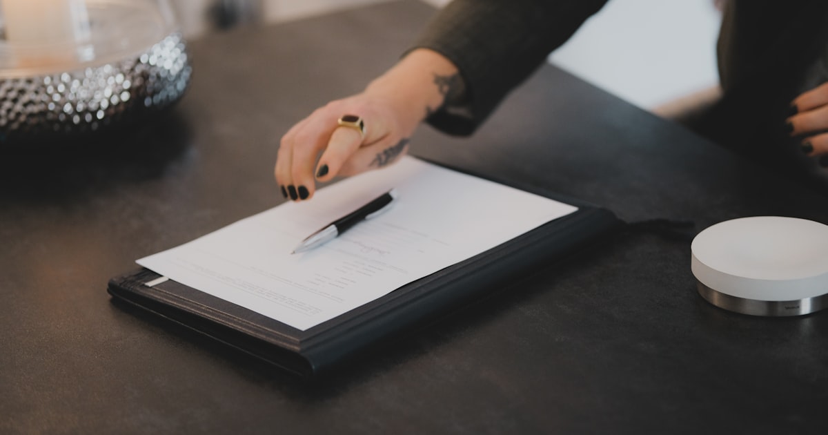 a person writing on a piece of paper
