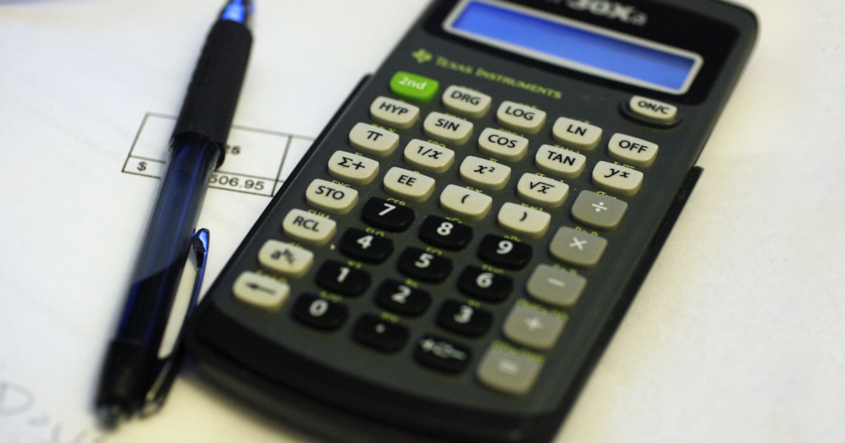 A calculator, pen, and documents for a test.