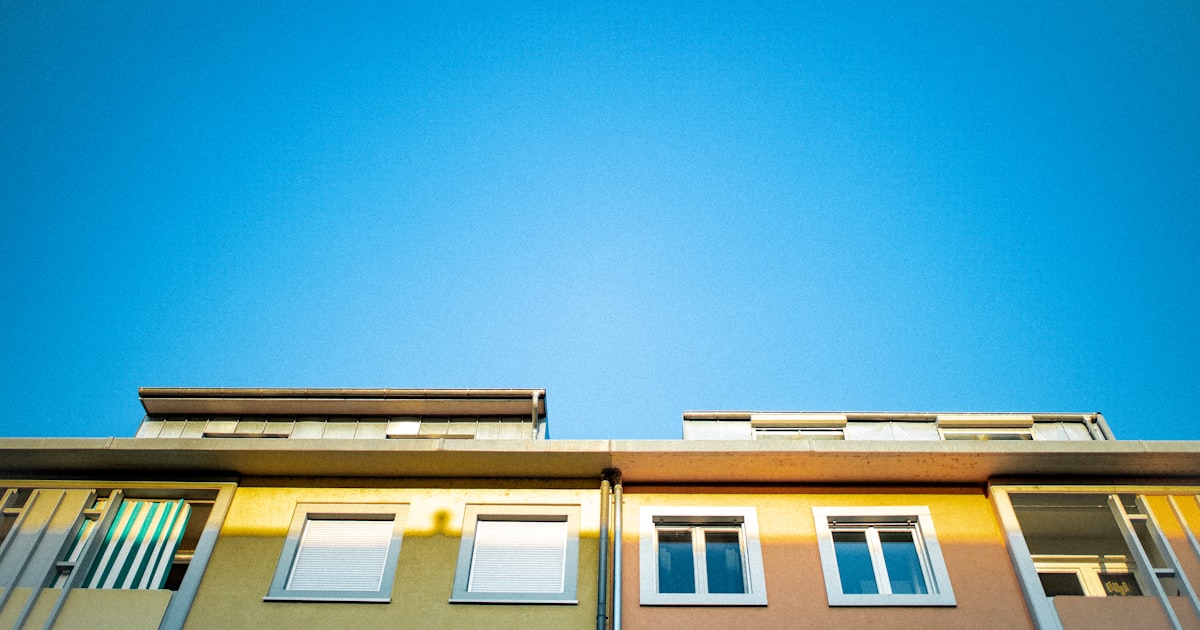 blue and white concrete building under blue sky during daytime