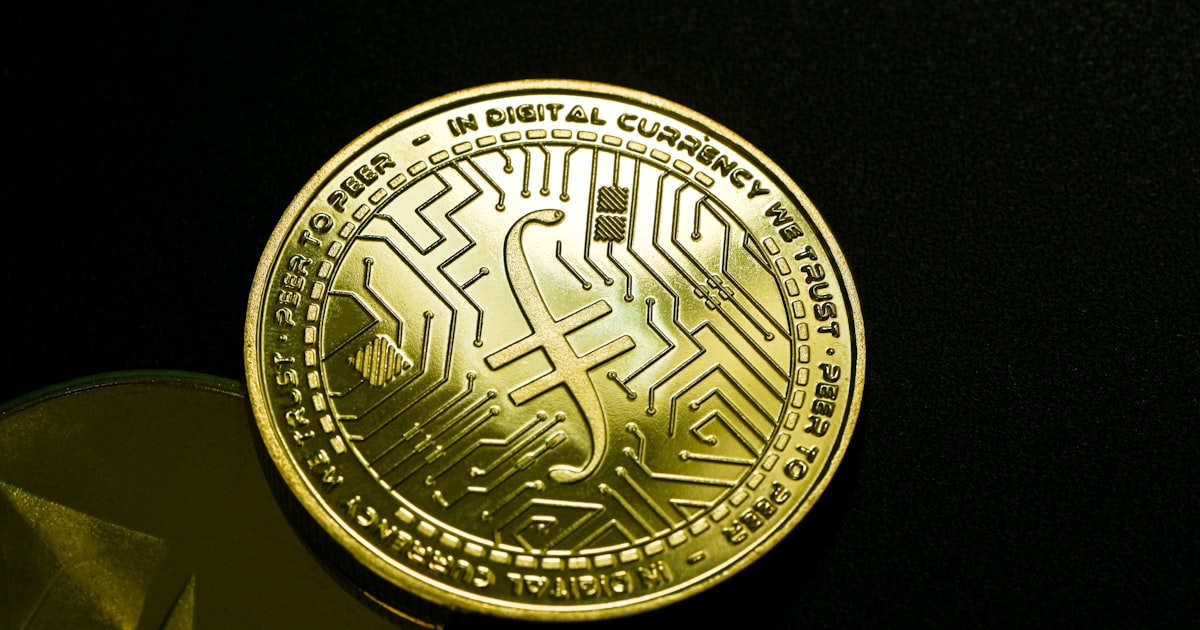 a close up of a gold coin on a black surface
