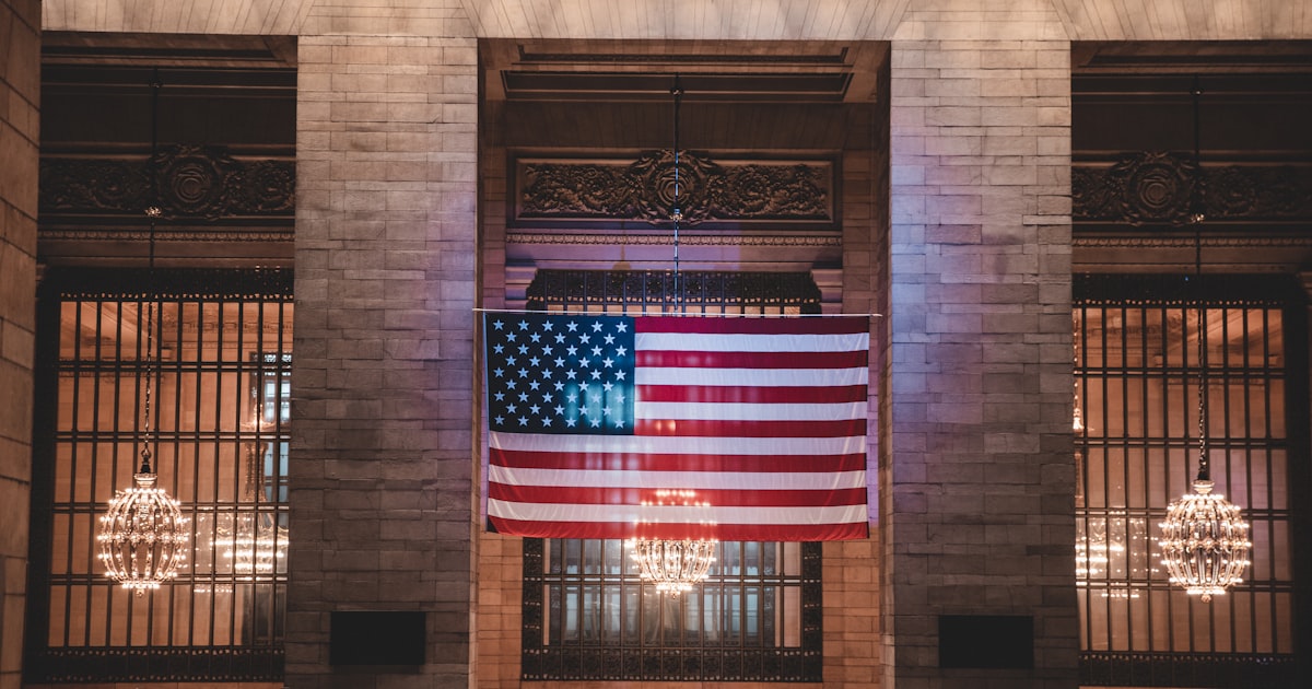 red and white flag on brown concrete building