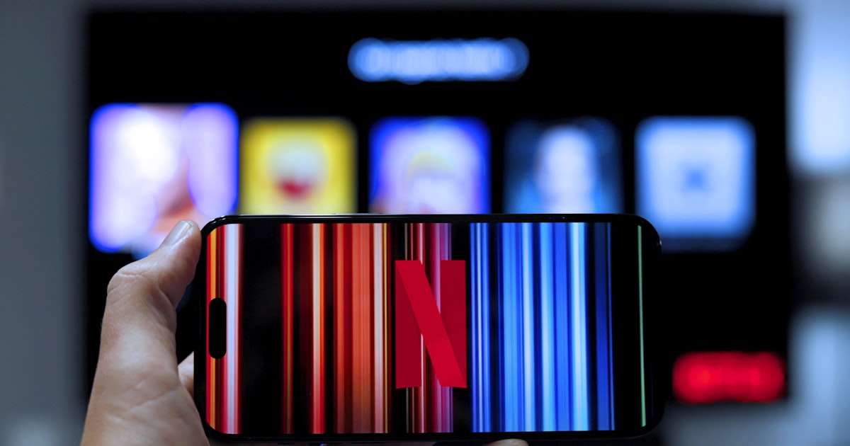 a person holding a cell phone with a bar code on it