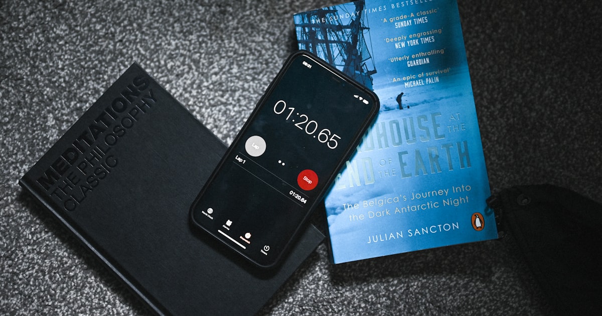 a cell phone sitting on top of a book