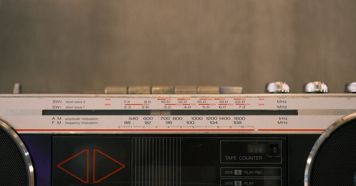 Here is a sentence: a vintage boombox is displayed in the picture.